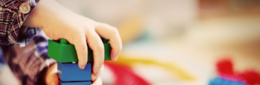 child building a tower of lego