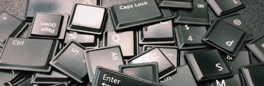 Loose black computer keys in a pile