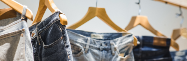 Demin jeans hanging on clothing rack