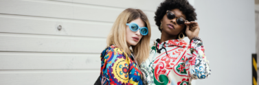 Two women posing in colourful prints