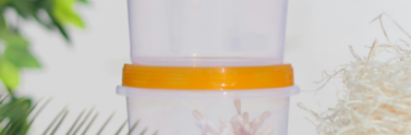 small plastic container with orange lid